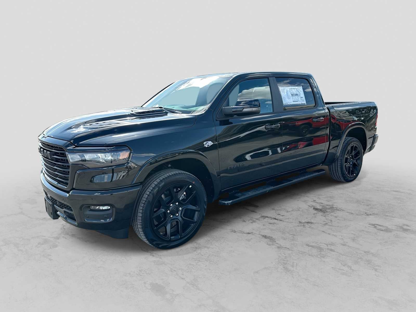 2026 RAM 1500 RAM 1500 LARAMIE CREW CAB 4X4 5'7' BOX in Diamond Black Crystal Pearl-Coat Exterior Paint — front three-quarter view